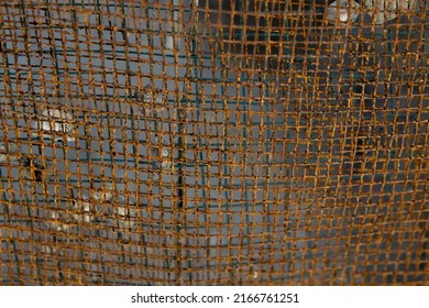 Closeup Detail Of A Rusted And Almost Broken Sand Sieve. Sieve Texture. Industrial Background