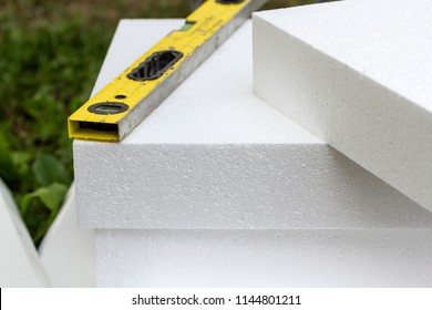 Close-up Detail Of Stack Of White Rigid Polyurethane Foam Sheets For House Insulation And Level. Modern Technology, Renovation, Professional Job, Energy Saving, Alternative For Mineral Wool Concept.