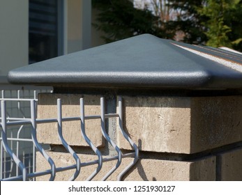 Close-up Detail Of Stone Fence Post With Silver Color Shiny Ceramic Cap Stone And Galvanized Welded Steel Grille Grating