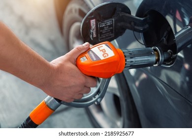 Close-up Detail View Of Fuel Autogas Pump Gun Connected With Noozle Adapter To Car Tank To Refill At Car Gas Filling Station. Refueling Vehicle With Liquefied Lpg Or Lng Product. Safety Technology