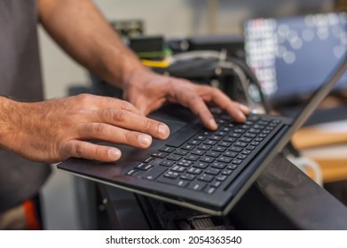 Closeup Detail View Of Laptop Computer. Field Service Maintenance Engineer Technician Electrician Inspect And Control Machine Hardware And Software System. Electric Installation