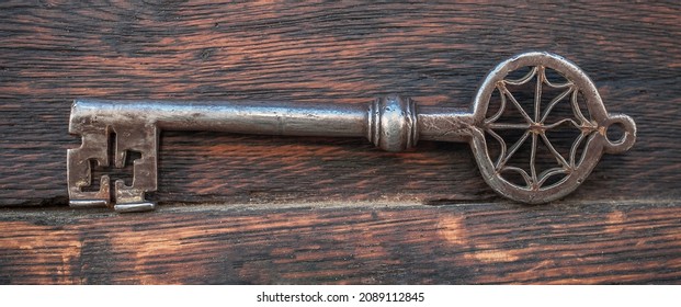Closeup detail view of old large huge massive metal key for entrance the church. Secret and mystery. Medieval security and safety
