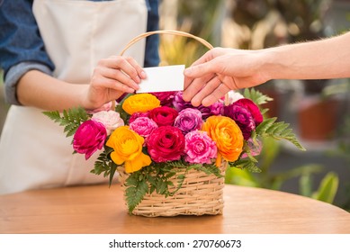 Close-up. Detail View Of Seller Florist Giving Visit Card To The Customer.