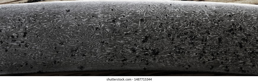 A close-up, detailed photograph of wootz crucible steel, also known as damascus steel or watered steel. 