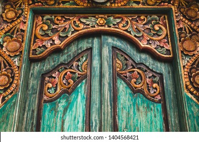 Close-up details of traditional balinese handmade carved wooden door. Bali style furniture with flowers ornament - Powered by Shutterstock