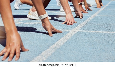 Closeup of determined group of athletes in starting position line to begin sprint or run race on sports track stadium. Hands of diverse sports people ready to compete in track and field olympic event