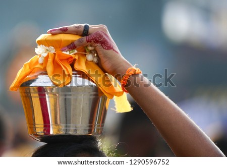 A closeup of devotee carrying a pot of milk as a show of devotion and love to Lord Murugan at Batu Caves during Thaipusam festival