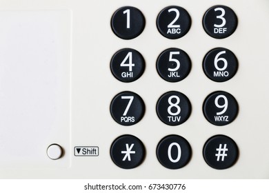 Close-up of dial number button on old used telephone and fax 