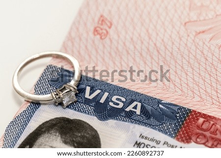 Close-up of a diamond ring on a US visa as an idea for a marriage move
