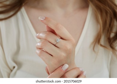 Close-up diamond ring on young lady's finger