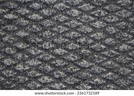 Closeup of diamond-patterned textures in cement
