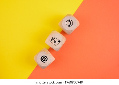 A closeup of dices with different communication symbols for companies on a yellow and orange surface - Shutterstock ID 1960908949