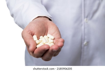 closeup of dietary medication. natural dietary supplement. doctors hand with dietary pills
