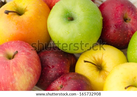 Closeup of different apples lying in a pile