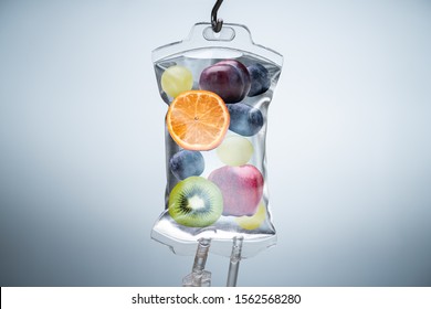 Close-up Of A Different Fruit Slices Inside Saline Bag Hanging With Hook In Hospital