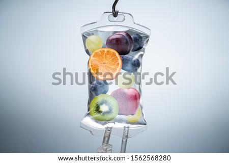 Close-up Of A Different Fruit Slices Inside Saline Bag Hanging With Hook In Hospital