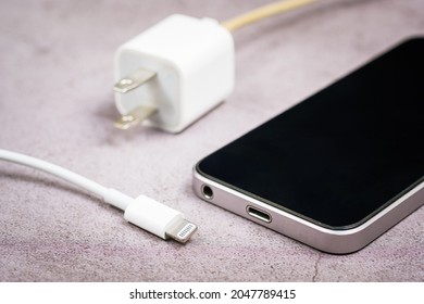 Closeup different size or incompatible usb head of charging wire and usb port on smartphone
