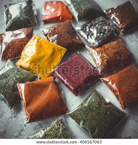 Close-up of different types of assorted spices in transparent bags