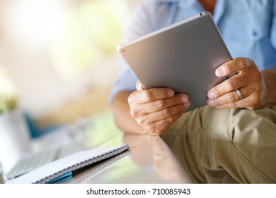 Closeup of digital tablet used by businessman - Shutterstock ID 710085943