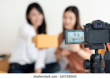 Closeup Of Digital Video Camera Recording Two Girls Presenting New Product Advertisement. Vlog And Influencer Concept. People Part Time Job And Occupation. Young Teenagers Using Modern Technology