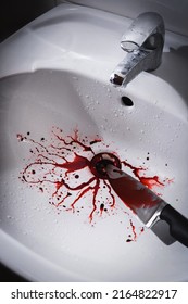 Closeup Of Dirty Bathroom Sink With Blood Splatter And Knife