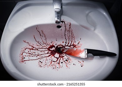 Closeup Of Dirty Bathroom Sink With Blood Splatter And Knife