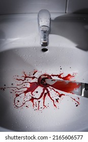 Closeup Of Dirty Bathroom Sink With Blood Splatter And Knife