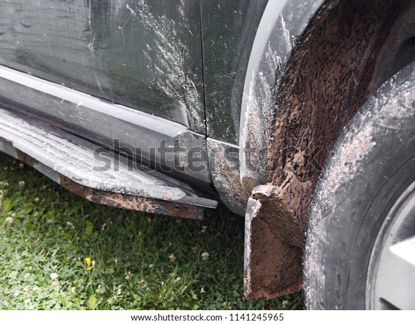 Closeup of a dirty car\
wheel and body