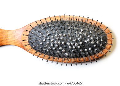 A Close-up Of A Dirty Hairbrush Over White Background