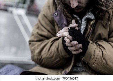 Close-up of dirty hands of beggar. Problems of homeless person in the city concept
