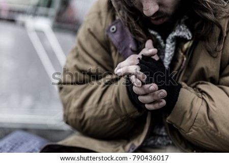 Close-up of dirty hands of beggar. Problems of homeless person in the city concept