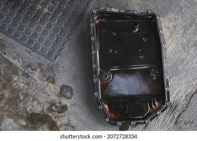 Close-up Of Dirty Oil On Automatic Transmission Oil Pan.