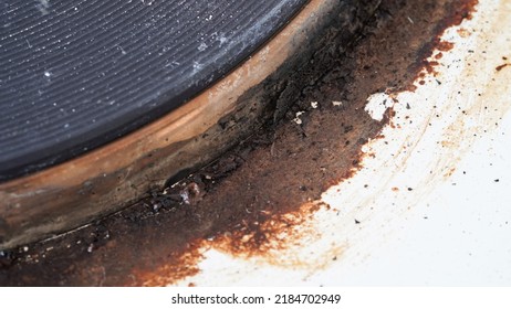 Close-up Of A Dirty Stove With Leftover Food. Dirty Gas Stove With Grease Stains, Old Grease Stains, Fried Stains And Oil Splashes.Macro Photo.Texture.