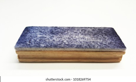 Closeup Of Dirty Wooden Whiteboard Eraser Isolated On White Background. Blue Ink Marker Stains On Whiteboards Duster Concept.