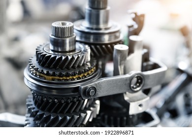Closeup disassembled car automatic transmission gear part on workbench at garage or repair factory station for fix service or maintenance. Vehicle part detail. Complex industrial mechanism background - Shutterstock ID 1922896871