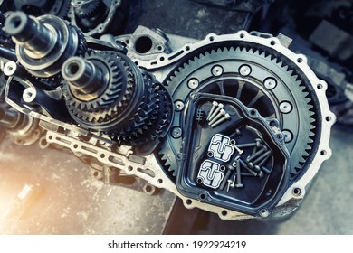 Closeup disassembled car automatic transmission gear part on workbench at garage or repair factory station for fix service or maintenance. Vehicle part detail. Complex industrial mechanism background - Shutterstock ID 1922924219