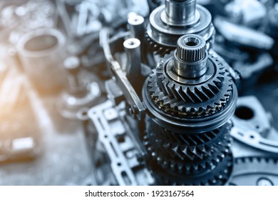 Closeup disassembled car automatic transmission gear part on workbench at garage or repair factory station for fix service or maintenance. Vehicle part detail. Complex industrial mechanism background - Shutterstock ID 1923167564