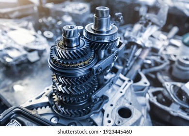 Closeup disassembled car automatic transmission gear part on workbench at garage or repair factory station for fix service or maintenance. Vehicle part detail. Complex industrial mechanism background