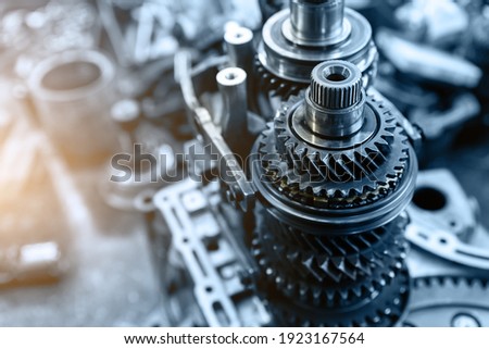 Closeup disassembled car automatic transmission gear part on workbench at garage or repair factory station for fix service or maintenance. Vehicle part detail. Complex industrial mechanism background ストックフォト © 