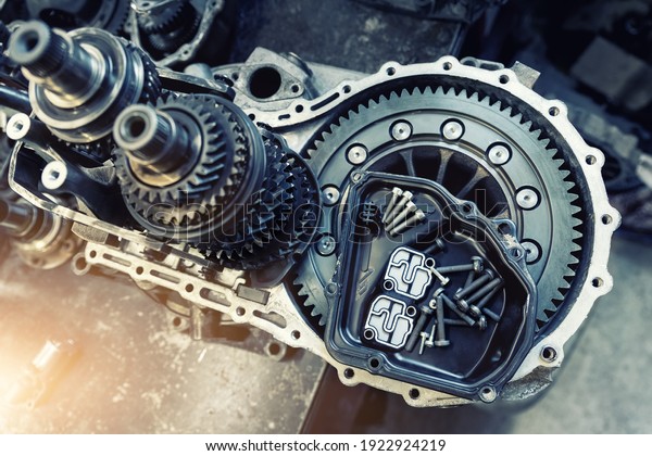 Closeup disassembled car automatic
transmission gear part on workbench at garage or repair factory
station for fix service or maintenance. Vehicle part detail.
Complex industrial mechanism
background