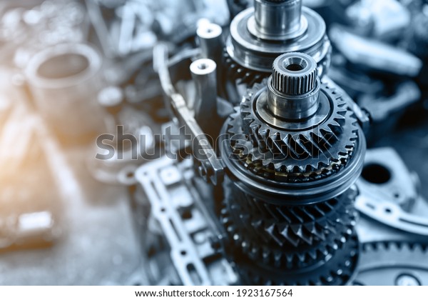 Closeup disassembled car automatic
transmission gear part on workbench at garage or repair factory
station for fix service or maintenance. Vehicle part detail.
Complex industrial mechanism
background