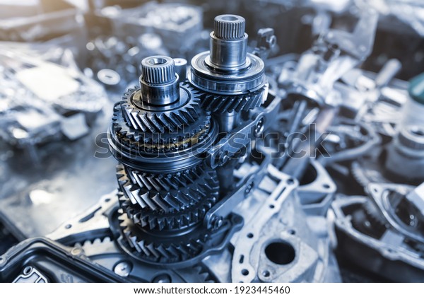 Closeup disassembled car automatic\
transmission gear part on workbench at garage or repair factory\
station for fix service or maintenance. Vehicle part detail.\
Complex industrial mechanism\
background