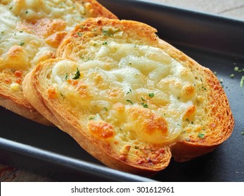 Close-up Of A Dish Of Garlic Bread With Cheese.