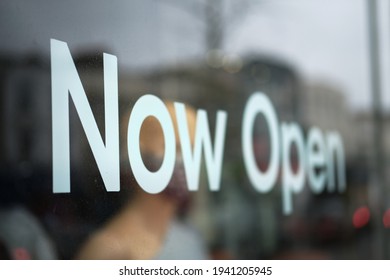 Close-up Of A Display Window Of A Small Business With The Words: Now Open After Easing The Restriction.