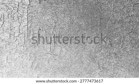 Close-up of a distressed gray surface with a network of fine cracks, creating an abstract textured background.