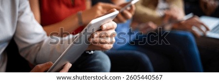 Close-up of diverse hands using tablets and smartphones. Technology and communication are key. Devices in focus, showing modern digital interaction. People using digital devices, social media.