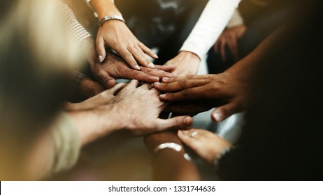 Closeup of diverse people joining their hands - Shutterstock ID 1331744636