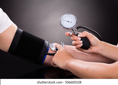 Close-up Of A Doctor Checking Blood Pressure O Patient