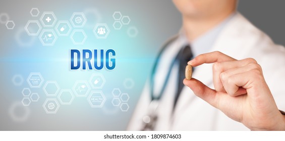 Close-up Of A Doctor Giving You A Pill With DRUG Inscription, Medical Concept