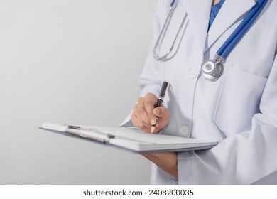 Close-up of a doctor hand holding pen and writing on medical form that attached to a clipboard. - Powered by Shutterstock